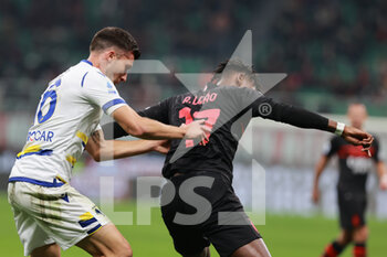 2021-10-16 - Rafael Leao of AC Milan fights for the ball against Nicolo Casale of Hellas Verona FC during the Serie A 2021/22 football match between AC Milan and Hellas Verona FC at Giuseppe Meazza Stadium, Milan, Italy on October 16, 2021 - AC MILAN VS HELLAS VERONA FC - ITALIAN SERIE A - SOCCER