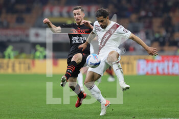 2021-10-26 - Ricardo Rodriguez of Torino FC fights for the ball against Alexis Saelemaekers of AC Milan during the Serie A 2021/22 football match between AC Milan and Torino FC at Giuseppe Meazza Stadium, Milan, Italy on October 26, 2021 - AC MILAN VS TORINO FC - ITALIAN SERIE A - SOCCER