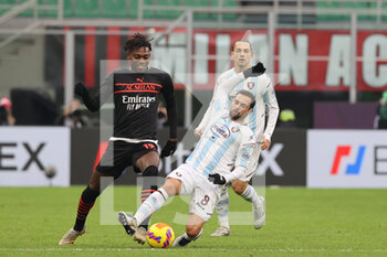 2021-12-04 - Rafael Leao of AC Milan fights for the ball against Andrea Schiavone of US Salernitana 1919 during the Serie A 2021/22 football match between AC Milan and US Salernitana 1919 at Giuseppe Meazza Stadium, Milan, Italy on December 04, 2021 - AC MILAN VS US SALERNITANA - ITALIAN SERIE A - SOCCER