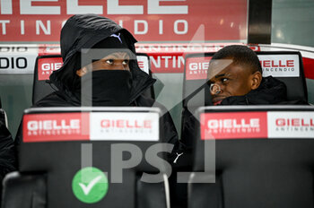 2021-12-11 - Milan's Franck Kessie and Milan's Pierre Kalulu portraits on the bench - UDINESE CALCIO VS AC MILAN - ITALIAN SERIE A - SOCCER