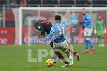 2021-12-19 - Hirving Lozano of SSC Napoli fights for the ball against Fodé Ballo-Touré of AC Milan during the Serie A 2021/22 football match between AC Milan and SSC Napoli at Giuseppe Meazza Stadium, Milan, Italy on December 19, 2021 - AC MILAN VS SSC NAPOLI - ITALIAN SERIE A - SOCCER