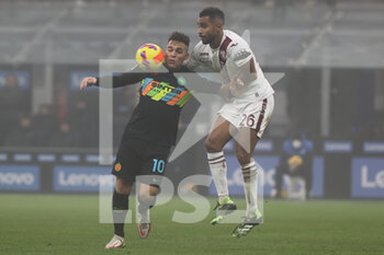 2021-12-22 - Lautaro Martinez of FC Internazionale fights for the ball against Koffi Djidji of Torino FC during the Serie A 2021/22 football match between FC Internazionale and Torino FC at Giuseppe Meazza Stadium, Milan, Italy on December 22, 2021 - INTER - FC INTERNAZIONALE VS TORINO FC - ITALIAN SERIE A - SOCCER