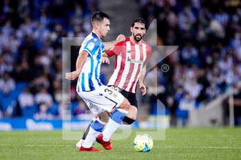 2021-10-31 - Martin Zubimendi of Real Sociedad and Raul Garcia of Athletic Club during the Spanish championship La Liga football match between Real Sociedad and Athletic Club on October 31, 2021 at Reale Arena in San Sebastian, Spain - REAL SOCIEDAD VS ATHLETIC CLUB - SPANISH LA LIGA - SOCCER