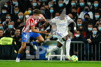 2021-12-12 - Vinicius Junior of Real Madrid and Marcos Llorente of Atletico de Madrid during the Spanish championship La Liga football match between Real Madrid and Atletico de Madrid on December 12, 2021 at Santiago Bernabeu stadium in Madrid, Spain - REAL MADRID VS ATLETICO DE MADRID - SPANISH LA LIGA - SOCCER