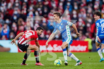 2021-12-19 - Sergio Canales of Real Betis Balompie and Mikel Balenziaga of Athletic Club during the Spanish championship La Liga football match between Athletic Club and Real Betis Balompie on December 19, 2021 at San Mames stadium in Bilbao, Spain - ATHLETIC CLUB VS REAL BETIS BALOMPIE - SPANISH LA LIGA - SOCCER