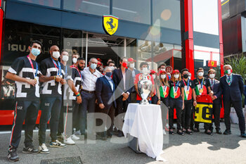 2021-09-12 - The Scuderia Ferrari drivers Leclerc Charles and Sainz Carlos, posing with Italian Olympic Games champions, TODT Jean (fra), FIA President, DOMENICALLI Stefano (ita), Chairman and CEO Formula One Group FOG, and Elkann John, Chairman and Chief Executive Officer of EXOR and Chairman of Fiat Chrysler, in the paddock with the Football Euro 2020 trophy, during the Formula 1 Heineken Gran Premio D'italia 2021, Italian Grand Prix, 14th round of the 2021 FIA Formula One World Championship from September 9 to 12, 2021 on the Autodromo Nazionale di Monza, in Monza, Italy - FORMULA 1 HEINEKEN GRAN PREMIO D'ITALIA 2021, ITALIAN GRAND PRIX, 14TH ROUND OF THE 2021 FIA FORMULA ONE WORLD CHAMPIONSHIP - FORMULA 1 - MOTORS