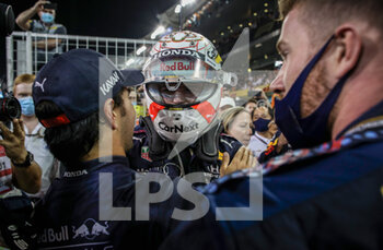 2021-12-12 - VERSTAPPEN Max (nld), Red Bull Racing Honda RB16B, portrait, celebrating his win and first world title at 24 years old with Sergio Perez during the Formula 1 Etihad Airways Abu Dhabi Grand Prix 2021, 22th round of the 2021 FIA Formula One World Championship from December 10 to 12, 2021 on the Yas Marina Circuit, in Yas Island, Abu Dhabi - FORMULA 1 ETIHAD AIRWAYS ABU DHABI GRAND PRIX 2021, 22TH ROUND OF THE 2021 FIA FORMULA ONE WORLD CHAMPIONSHIP - FORMULA 1 - MOTORS