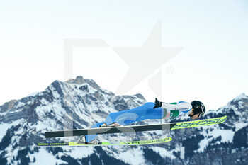 2021-12-18 - December 18, 2021, Engelberg, Gross-Titlis-Schanze, FIS Ski Jumping World Cup Engelberg, Gregor Deschwanden SUI jumps from the hill (in action); with mountain landscape in the background - 2021 FIS SKI JUMPING WORLD CUP - NORDIC SKIING - WINTER SPORTS