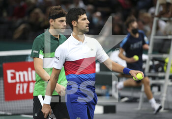 2021-11-01 - Novak Djokovic of Serbia and teammate Filip Krajinovic of Serbia (green shirt) during their double match on day 1 of the Rolex Paris Masters 2021, an ATP Masters 1000 tennis tournament on November 1, 2021 at Accor Arena in Paris, France - ROLEX PARIS MASTERS 2021, AN ATP MASTERS 1000 TENNIS TOURNAMENT - INTERNATIONALS - TENNIS