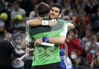 2021-11-01 - Novak Djokovic of Serbia and teammate Filip Krajinovic of Serbia (green shirt) celebrate winning their doubles match on day 1 of the Rolex Paris Masters 2021, an ATP Masters 1000 tennis tournament on November 1, 2021 at Accor Arena in Paris, France - ROLEX PARIS MASTERS 2021, AN ATP MASTERS 1000 TENNIS TOURNAMENT - INTERNATIONALS - TENNIS