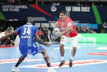 2022-01-30 - Mads Mensah of Denmark and Karl Konan of France during the EHF Men's Euro 2022, Placement Match 3/4 handball match between France and Denmark on January 30, 2022 at Budapest Multifunctional Arena in Budapest, Hungary - EHF MEN'S EURO 2022, PLACEMENT MATCH 3/4 - FRANCE VS DENMARK - HANDBALL - OTHER SPORTS