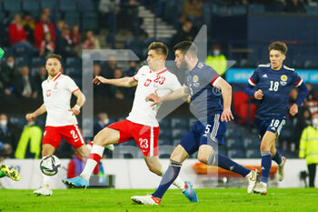 2022-03-24 - Krzysztof Piatek of Poland and Grant Hanley of Scotland during the International Friendly football match between Scotland and Poland on March 24, 2022 at Hampden Park in Glasgow, Scotland - SCOTLAND VS POLAND - FRIENDLY MATCH - SOCCER