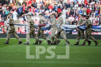 2022-03-26 - LONDON, ENGLAND - MARCH 26: during the international friendly match between England and Switzerland at Wembley Stadium on March 26, 2022 in London, United Kingdom. Soldiers with Union Jack flag - ENGLAND VS SWITZERLAND - FRIENDLY MATCH - SOCCER