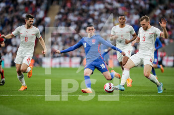 2022-03-26 - LONDON, ENGLAND - MARCH 26: during the international friendly match between England and Switzerland at Wembley Stadium on March 26, 2022 in London, United Kingdom. Phil Foden of England against Silvan Widmer of Switzerland and Remo Freuler of Switzerland - ENGLAND VS SWITZERLAND - FRIENDLY MATCH - SOCCER