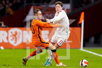 2022-03-26 - Teun Koopmeiners of the Netherlands challenges Andreas Skov Olsen of Denmark during the International Friendly football match between Netherlands and Denmark on March 26, 2022 at the Johan Cruijff ArenA in Amsterdam, Netherlands - NETHERLANDS VS DENMARK - FRIENDLY MATCH - SOCCER