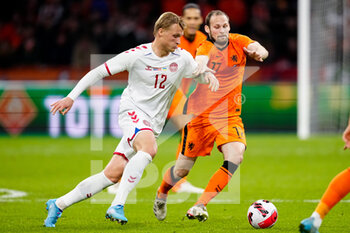 2022-03-26 - Kasper Dolberg of Denmark is challenged by Daley Blind of the Netherlands during the International Friendly football match between Netherlands and Denmark on March 26, 2022 at the Johan Cruijff ArenA in Amsterdam, Netherlands - NETHERLANDS VS DENMARK - FRIENDLY MATCH - SOCCER