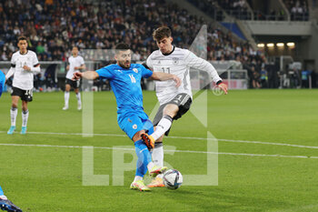 2022-03-26 - Kai Havertz of Germany and Mohammad Abu Fani of Israel during the International Friendly football match between Germany and Israel on March 26, 2022 at PreZero Arena in Sinsheim, Germany - GERMANY VS ISRAEL - FRIENDLY MATCH - SOCCER
