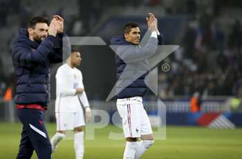 2022-03-29 - Raphael Varane, goalkeeper of France Hugo Lloris (left) salute the supporters following the International Friendly football match between France and South Africa on March 29, 2022 at Stade Pierre Mauroy in Villeneuve-d'Ascq near Lille, France - FRANCE VS SOUTH AFRICA - FRIENDLY MATCH - SOCCER