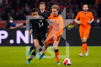 2022-03-29 - Jamal Musiala of Germany battles for the ball with Frenkie de Jong of the Netherlands during the International Friendly football match between Netherlands and Germany on March 29, 2022 at the Johan Cruijff ArenA in Amsterdam, Netherlands - NETHERLANDS VS GERMANY - FRIENDLY MATCH - SOCCER
