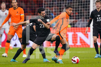 2022-03-29 - Ilkay Gundogan of Germany battles for the ball with Donyell Malen of the Netherlands during the International Friendly football match between Netherlands and Germany on March 29, 2022 at the Johan Cruijff ArenA in Amsterdam, Netherlands - NETHERLANDS VS GERMANY - FRIENDLY MATCH - SOCCER