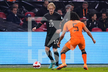 2022-03-29 - Julian Brandt of Germany battles for the ball with Nathan Ake of the Netherlands during the International Friendly football match between Netherlands and Germany on March 29, 2022 at the Johan Cruijff ArenA in Amsterdam, Netherlands - NETHERLANDS VS GERMANY - FRIENDLY MATCH - SOCCER