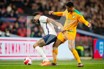 2022-03-29 - England defender Tyrone Mings (5) battles for possession with Ivory Coast forward Sebastien Haller during the Friendly football match between England and Ivory Coast on March 29, 2022 at Wembley Stadium in London, England - ENGLAND VS IVORY COAST - FRIENDLY MATCH - SOCCER