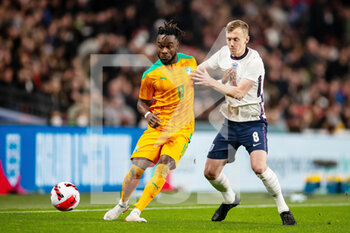 2022-03-29 - Ivory Coast forward Maxwel Cornet (11) battles for possession with England midfielder James Ward-Prowse during the Friendly football match between England and Ivory Coast on March 29, 2022 at Wembley Stadium in London, England - ENGLAND VS IVORY COAST - FRIENDLY MATCH - SOCCER