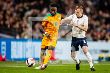 2022-03-29 - Ivory Coast forward Maxwel Cornet (11) battles for possession with England midfielder James Ward-Prowse during the Friendly football match between England and Ivory Coast on March 29, 2022 at Wembley Stadium in London, England - ENGLAND VS IVORY COAST - FRIENDLY MATCH - SOCCER