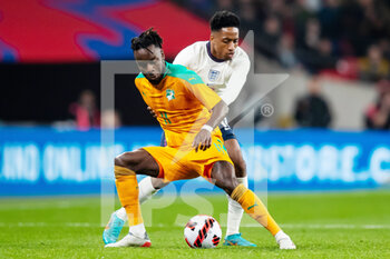2022-03-29 - Ivory Coast forward Maxwel Cornet (11) with England defender Kyle Walker-Peters during the Friendly football match between England and Ivory Coast on March 29, 2022 at Wembley Stadium in London, England - ENGLAND VS IVORY COAST - FRIENDLY MATCH - SOCCER