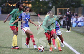 2022-06-25 - Flora Kameni Djientieu of Cameroon, left Easther Mayi Kith of Cameroon, Delphine Cascarino of France during the Women's Friendly football match between France and Cameroon on June 25, 2022 at Stade Pierre Brisson in Beauvais, France - FOOTBALL - WOMEN'S FRIENDLY GAME - FRANCE V CAMEROON - FRIENDLY MATCH - SOCCER