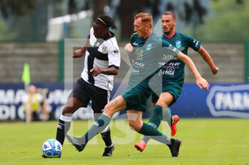 2022-07-23 - Woyo Coulibaly of PARMA CALCIO competes for the ball with a player of FERALPISALO’ during the friendly match between Parma Calcio and FeralpiSalò on July 23, 2022 in Pinzolo (TN), Italy. - PARMA CALCIO VS FERALPISALò - FRIENDLY MATCH - SOCCER