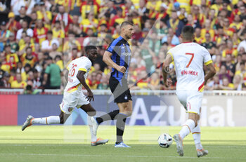 2022-07-23 - Edin Dzeko of Inter Milan, Samed Abdul of Lens (left) during the Pre-Season Friendly football match between RC Lens and Inter Milan (FC Internazionale) on July 23, 2022 at Stade Bollaert-Delelis in Lens, France - FOOTBALL - FRIENDLY GAME - LENS V FC INTER - INTERNAZIONALE - FRIENDLY MATCH - SOCCER