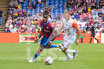 2022-07-30 - Crystal Palace forward Wilfried Zaha and Arnaud Souquet of Montpellier during the Pre-Season Friendly football match between Crystal Palace and Montpellier HSC on July 30, 2022 at Selhurst Park in London, England - FOOTBALL - FRIENDLY GAME - CRYSTAL PALACE V MONTPELLIER - FRIENDLY MATCH - SOCCER