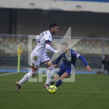 2022-12-22 - Charalampos Lykogiannis of Bologna FC competes for the ball with Darko Lazovic of Hellas Verona FC during Hellas Verona vs Bologna FC, frendly match Serie A Tim 2022-23, at Marcantonio Bentegodi stadium in Verona (VR), Italy, on December 22, 2022. - HELLAS VERONA FC VS BOLOGNA FC - FRIENDLY MATCH - SOCCER