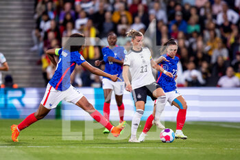 2022-07-27 - Alexandra Popp of Germany and Wendie Renard, Eve Perisset of France during the UEFA Women's Euro 2022, semi final football match between Germany and France on July 27, 2022 at stadium:mk in Milton Keynes, England - FOOTBALL - WOMEN'S EURO 2022 - 1/2 - GERMANY V FRANCE - UEFA EUROPEAN - SOCCER