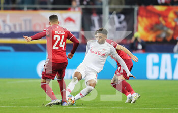 2022-02-16 - Chikwubuike Adamu of RB Salzburg and Corentin Tolisso of Bayern Munich during the UEFA Champions League, Round of 16, 1st leg football match between RB Salzburg and Bayern Munich on February 16, 2022 at Red Bull Arena in Salzburg, Austria - RB SALZBURG VS BAYERN MUNICH - UEFA CHAMPIONS LEAGUE - SOCCER