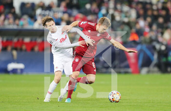 2022-02-16 - Joshua Kimmich of Bayern Munich and Brenden Aaronson of RB Salzburg during the UEFA Champions League, Round of 16, 1st leg football match between RB Salzburg and Bayern Munich on February 16, 2022 at Red Bull Arena in Salzburg, Austria - RB SALZBURG VS BAYERN MUNICH - UEFA CHAMPIONS LEAGUE - SOCCER
