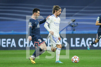 2022-03-09 - Luka Modric of Real Madrid and Lionel Messi of PSG during the UEFA Champions League, Round of 16, 2nd leg football match between Real Madrid and Paris Saint-Germain on March 9, 2022 at Santiago Bernabeu stadium in Madrid, Spain - REAL MADRID VS PARIS SAINT-GERMAIN - UEFA CHAMPIONS LEAGUE - SOCCER