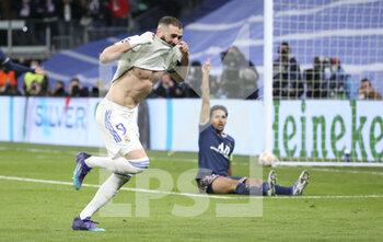 2022-03-09 - Karim Benzema of Real Madrid celebrates his goal while Marquinhos of PSG looks on during the UEFA Champions League, Round of 16, 2nd leg football match between Real Madrid and Paris Saint-Germain (PSG) on March 9, 2022 at Santiago Bernabeu stadium in Madrid, Spain - REAL MADRID VS PARIS SAINT-GERMAIN - UEFA CHAMPIONS LEAGUE - SOCCER