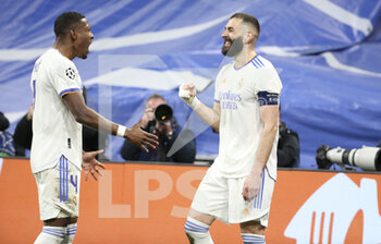 2022-03-09 - Karim Benzema of Real Madrid celebrates his second goal with David Alaba (left) during the UEFA Champions League, Round of 16, 2nd leg football match between Real Madrid and Paris Saint-Germain (PSG) on March 9, 2022 at Santiago Bernabeu stadium in Madrid, Spain - REAL MADRID VS PARIS SAINT-GERMAIN - UEFA CHAMPIONS LEAGUE - SOCCER