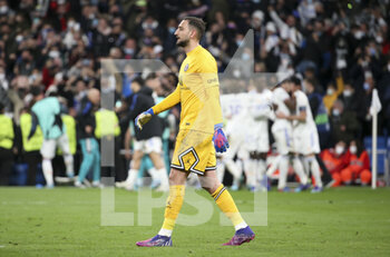 2022-03-09 - Goalkeeper of PSG Gianluigi Donnarumma looks on while Karim Benzema of Real Madrid celebrates his goal with teammates during the UEFA Champions League, Round of 16, 2nd leg football match between Real Madrid and Paris Saint-Germain (PSG) on March 9, 2022 at Santiago Bernabeu stadium in Madrid, Spain - REAL MADRID VS PARIS SAINT-GERMAIN - UEFA CHAMPIONS LEAGUE - SOCCER