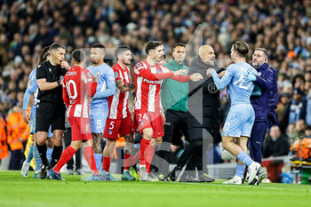 2022-04-05 - Pep Guardiola Manager of Manchester City holds back Jack Grealish (10) of Manchester City during the UEFA Champions League, Quarter-finals, 1st leg football match between Manchester City and Atletico Madrid on April 5, 2022 at the Etihad Stadium in Manchester, England - MANCHESTER CITY VS ATLETICO MADRID - UEFA CHAMPIONS LEAGUE - SOCCER