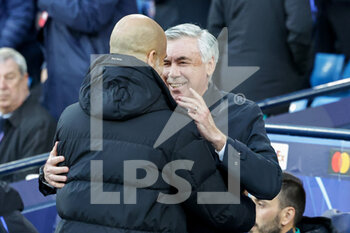 2022-04-26 - Pep Guardiola Manager of Manchester City greets Carlo Ancelotti Manager of Real Madrid during the UEFA Champions League, Semi-finals, 1st leg football match between Manchester City and Real Madrid on April 26, 2022 at the Etihad Stadium in Manchester, England - MANCHESTER CITY VS REAL MADRID - UEFA CHAMPIONS LEAGUE - SOCCER