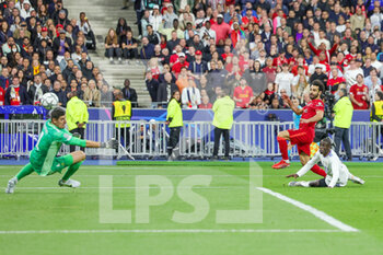 2022-05-28 - Mohamed Salah (11) of Liverpool shoots towards the goal, Thibaut Courtois of Real Madrid saves during the UEFA Champions League, Final football match between Liverpool FC and Real Madrid CF on May 28, 2022 at Stade de France in Saint-Denis near Paris, France - FOOTBALL - CHAMPIONS LEAGUE - FINAL - LIVERPOOL V REAL MADRID - UEFA CHAMPIONS LEAGUE - SOCCER