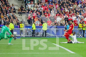 2022-05-28 - Mohamed Salah (11) of Liverpool shoots towards the goal, Thibaut Courtois of Real Madrid saves during the UEFA Champions League, Final football match between Liverpool FC and Real Madrid CF on May 28, 2022 at Stade de France in Saint-Denis near Paris, France - FOOTBALL - CHAMPIONS LEAGUE - FINAL - LIVERPOOL V REAL MADRID - UEFA CHAMPIONS LEAGUE - SOCCER