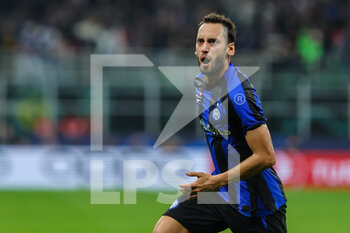 2022-10-04 - Hakan Calhanoglu of FC Internazionale celebrates after scoring a goal during the UEFA Champions League 2022/23 Group Stage - Group C football match between FC Internazionale and FC Barcelona at Giuseppe Meazza Stadium, Milan, Italy on October 04, 2022 - INTER - FC INTERNAZIONALE VS FC BARCELONA - UEFA CHAMPIONS LEAGUE - SOCCER