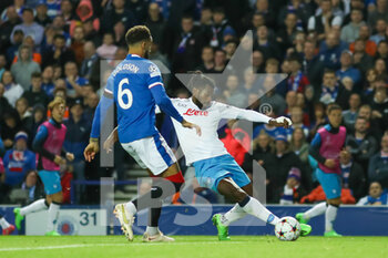 2022-09-14 - André-Frank Zambo Anguissa (#99) of SSC Napoli drags the ball back under the watchful eye of Connor Goldson (#6) of Rangers FC during the Champions League match between Rangers and Napoli at Ibrox, Glasgow, Scotland on 14 September 2022. Photo Colin Poultney / ProSportsImages / DPPI - FOOTBALL - CHAMPIONS LEAGUE - RANGERS V NAPOLI - UEFA CHAMPIONS LEAGUE - SOCCER
