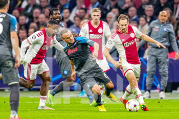 2022-10-04 - Stanislav Lobotka of Napoli, Steven Bergwijn and Daley Blind of Ajax during the UEFA Champions League, Group A football match between Ajax and Napoli on October 4, 2022 at Johan Cruijff ArenA in Amsterdam, Netherlands - FOOTBALL - CHAMPIONS LEAGUE - AJAX V NAPOLI - UEFA CHAMPIONS LEAGUE - SOCCER