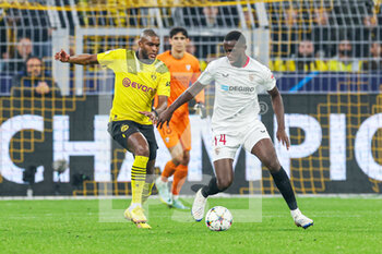 2022-10-11 - Nianzou Tanguy Kouassi of Sevilla, Anthony Modeste of Borussia Dortmund during the UEFA Champions League, Group G football match between Borussia Dortmund and Sevilla FC on October 11, 2022 at Signal Iduna Park in Dortmund, Germany - FOOTBALL - CHAMPIONS LEAGUE - BORUSSIA DORTMUND V SEVILLA - UEFA CHAMPIONS LEAGUE - SOCCER