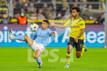 2022-10-25 - Joao Cancelo (7) of Manchester City tries to clear the ball from Karim Adeyemi (27) of Borussia Dortmund during the UEFA Champions League, Group G football match between Borussia Dortmund and Manchester City on October 25, 2022 at Signal Iduna Park in Dortmund, Germany - FOOTBALL - CHAMPIONS LEAGUE - DORTMUND V MANCHESTER CITY - UEFA CHAMPIONS LEAGUE - SOCCER